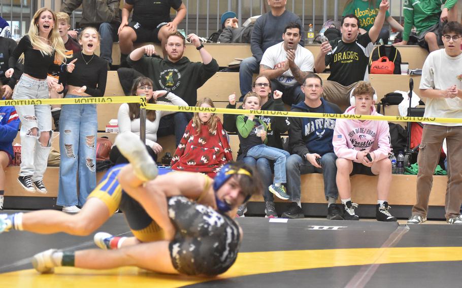 The home crowd goes wild Friday, Feb. 9, 2024, as Wiesbaden’s Munro Davis earns a match-winning takedown in overtime in a tough battle with Stuttgart’s Aidan Morgan at 132 pounds at the DODEA European Wrestling Championships in Wiesbaden, Germany.