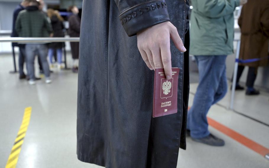 Ivan, 23, of Russia waits in a queue to have his passport checked at the Vaalimaa border checkpoint in Virolahti, Finland, on Sept. 25, 2022.