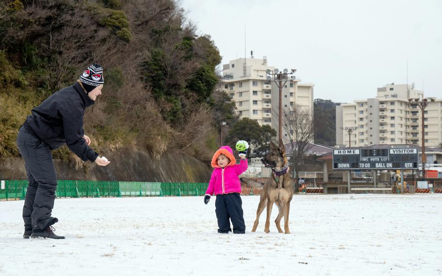 Family members enjoy the snow at the Ikego housing detachment near Yokosuka Naval Base, Japan, Tuesday, Feb. 6, 2024.