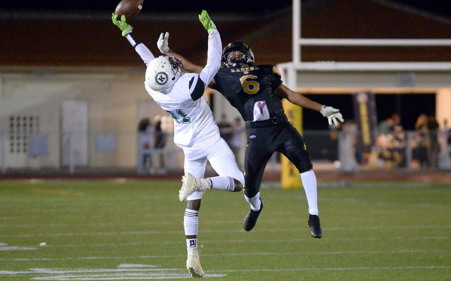 Kubasaki's Malachi Pinkston and Kadena's Kai Christy can't quite find the handle on the ball.