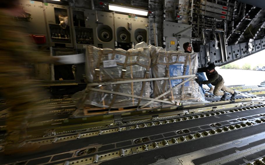 U.S. Air Force airmen and U.S. Agency for International Development workers offload more than 54,000 pounds of humanitarian aid from a C-17 Globemaster in Egypt on Nov. 28, 2023. The aid includes medical supplies, clothing and food destined for Gaza.