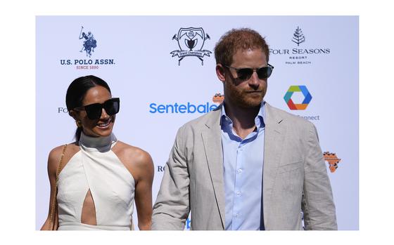 FILE - Britain's Prince Harry, right, and wife Meghan Markle, Duchess of Sussex, arrive for the 2024 Royal Salute Polo Challenge to Benefit Sentebale, on April 12, 2024, in Wellington, Fla. Prince Harry’s fight for police protection in the U.K. has received another setback. A judge on Monday, April 15, 2024 rejected his request to appeal an earlier ruling upholding a government panel’s decision to limit his access to publicly funded security after he quit as a working member of the royal family. (AP Photo/Rebecca Blackwell, File)