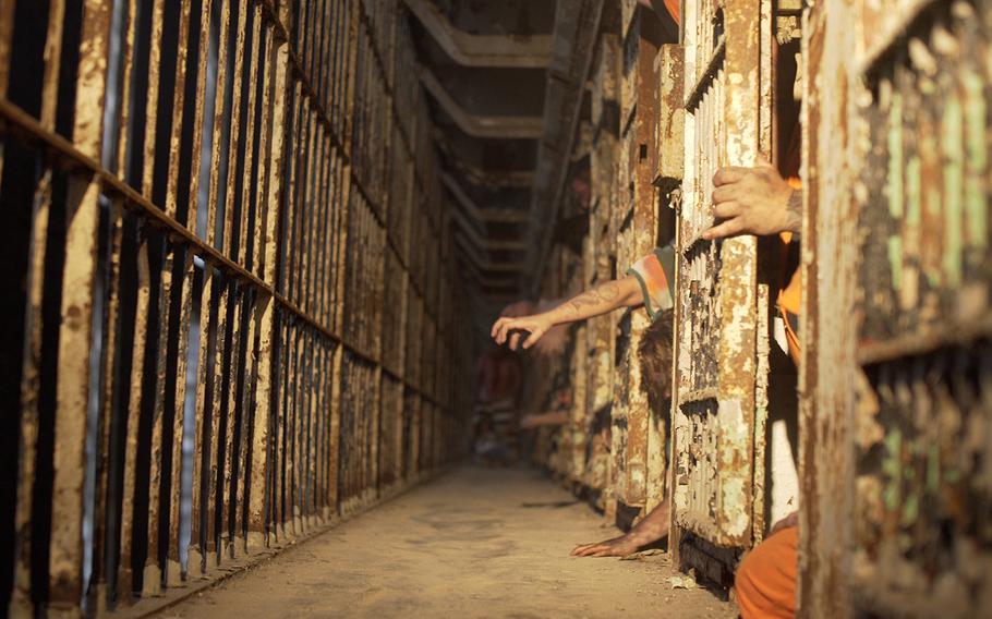 Pay extra during the 90-minute “Escape From Blood Prison” tour to allow yourself to be touched by scare actors, such as these prisoners reaching out from their cells. 