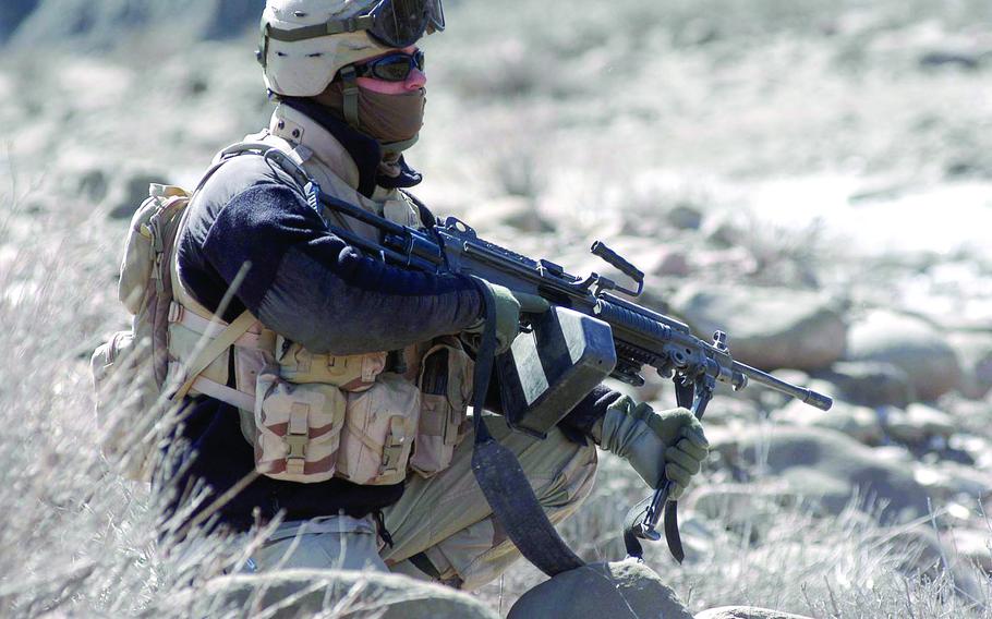 Pfc. Kiel Muston of the 1st Battalion, 508th Infantry Regiment’s mortar section scans the countryside during a stop on the way to Naka, Afghanistan, March 24, 2005