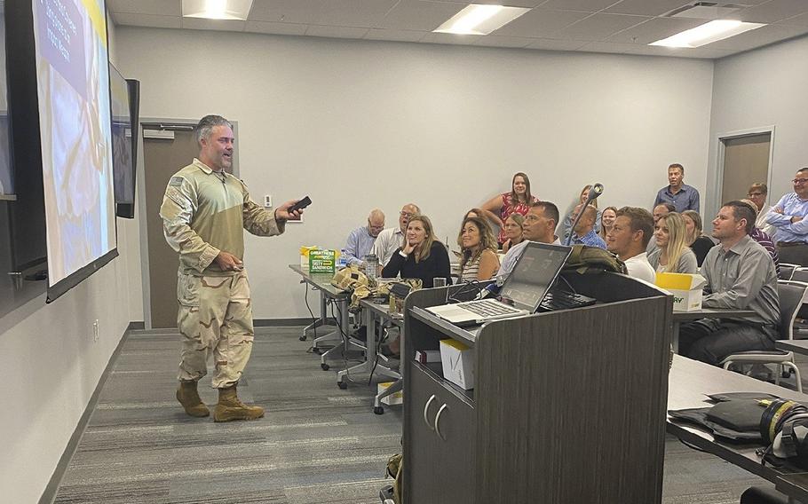 Navy SEAL veteran Phillip Koontz, left, speaks at a training event as seen in a photo posted on Aug. 25, 2022.