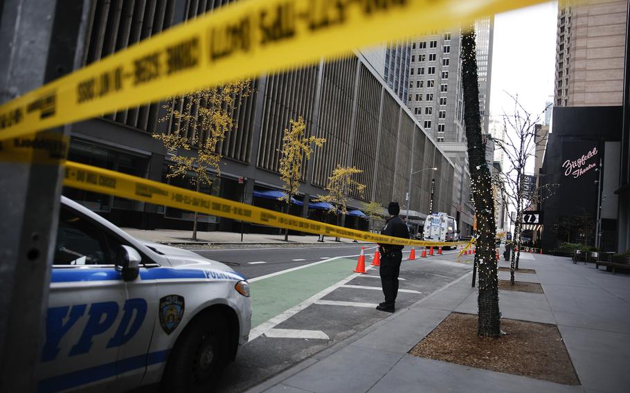 A New York police officer stands outside the Hilton Hotel in midtown Manhattan.