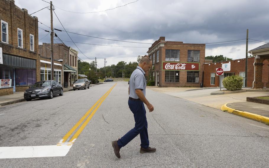 Billy Coleburn, owner of the local newspaper and former mayor of Blackstone, walks down Main Street in September 2021. 