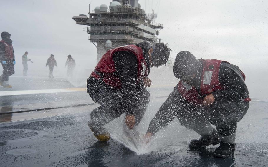 Sailor use welding rods to clear a nozzle aboard the aircraft carrier USS Nimitz while underway in the Pacific Ocean, Sept. 14, 2022. Tests of water used for drinking, bathing and cooking on the ship revealed traces of fuel, the Navy said this month.