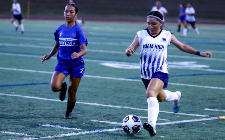 Aubrey Ibanez, right, outracing Notre Dame's Kalle Damian to the ball, scored three second-half goals for Guam High to put Friday's final out of reach.