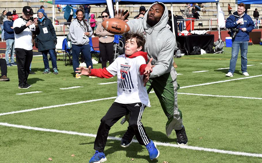 New England Patriots outside linebacker defends a pass to Ethaniel Gonzalez, 12, during the Matthew Judon Football ProCamp on March 23, 2024, at Kaiserslautern High School in Kaiserslautern, Germany.