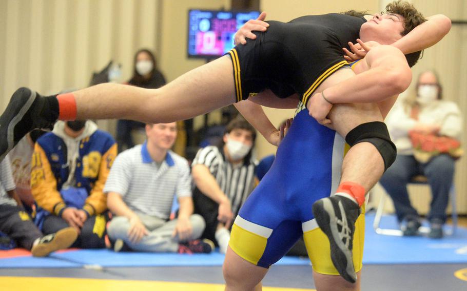 Toy Williams hoists American School In Japan’s Shawn Dobberfuhl into the air during Tuesday’s 215-pound fiinal in the Azabu Ward year-end international open wrestling tournament in Tokyo. Williams, a former Osan wrestler now attending college in South Carolina, edged Dobberfuhl 8-7 in overtime.