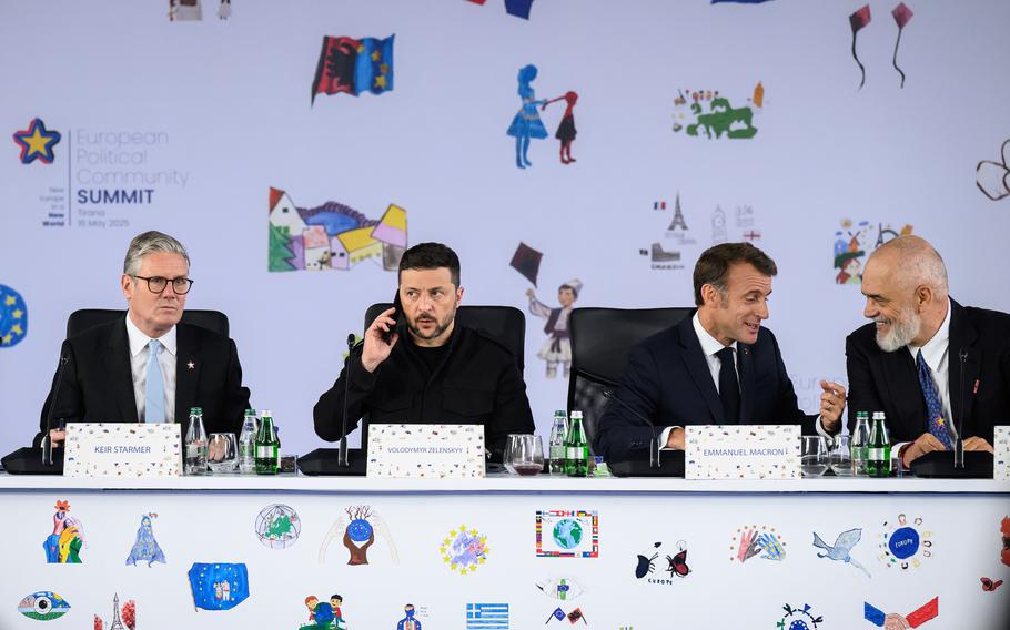 British Prime Minister Keir Starmer, Ukraine’s President Volodymyr Zelenskyy, France’s President Emmanuel Macron and Albania’s Prime Minister Edi Rama sitting at a table.