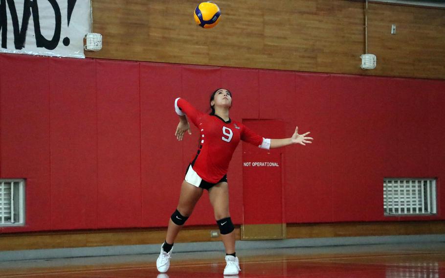 Ai Kina serves.