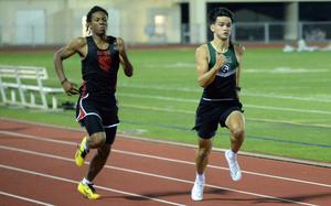 Kubasaki's Ryan Hater, right, outdistances Jeremiah Tucker of Okinawa Christian International during Friday's boys 200-meter dash. Hater ran the event in 21.98 seconds, with Tucker next in 22.16. Hater completed a rare feat in which he has run the 100 in under 11 seconds, the 200 in under 22 and the 800 in less than 2 minutes.
