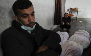 Palestinians mourn over the bodies of Al-Mashharawi family members, who were killed in an Israeli airstrike that hit their home, at Al-Ahli Hospital in Gaza City on Saturday, March 22, 2025. (AP Photo/Jehad Alshrafi)