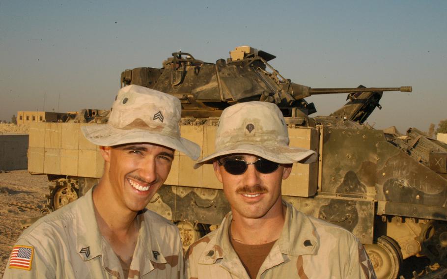 Two members of the 1st Battalion, 9th Infantry Regiment Manchus Sgt. John Eimers, 24, of Chicago, Ill., and Spc. Andrew Palmieri, 24, of San Diego, Calif., show off their new mustaches in front of the Myrth Mobile in Iraq.