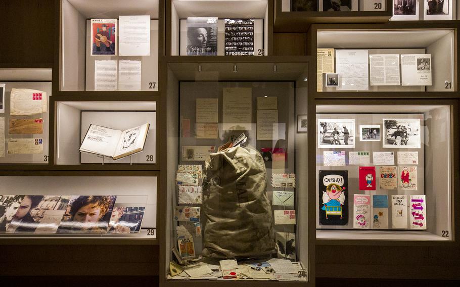 A wall of archive items contains, among other things, the bag that was found full of unopened mail from fans. 