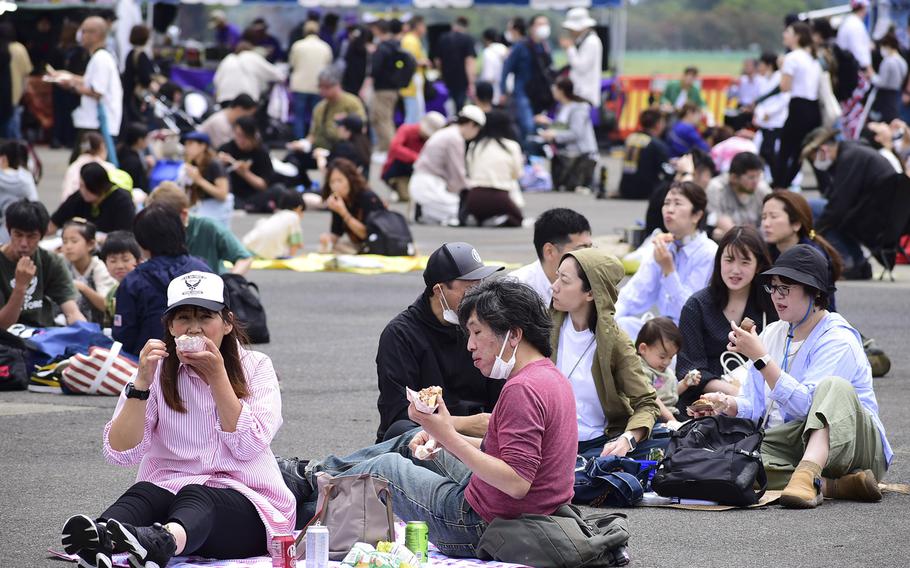 Visitors enjoy snacks on the flight line during the 47th annual Friendship Festival at Yokota Air Base, Japan, Saturday, May 20, 2023.