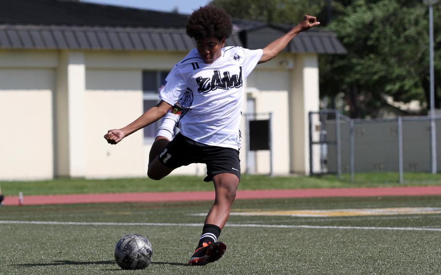 Zama's Syon Phillips kicks the ball upfield against Osan.