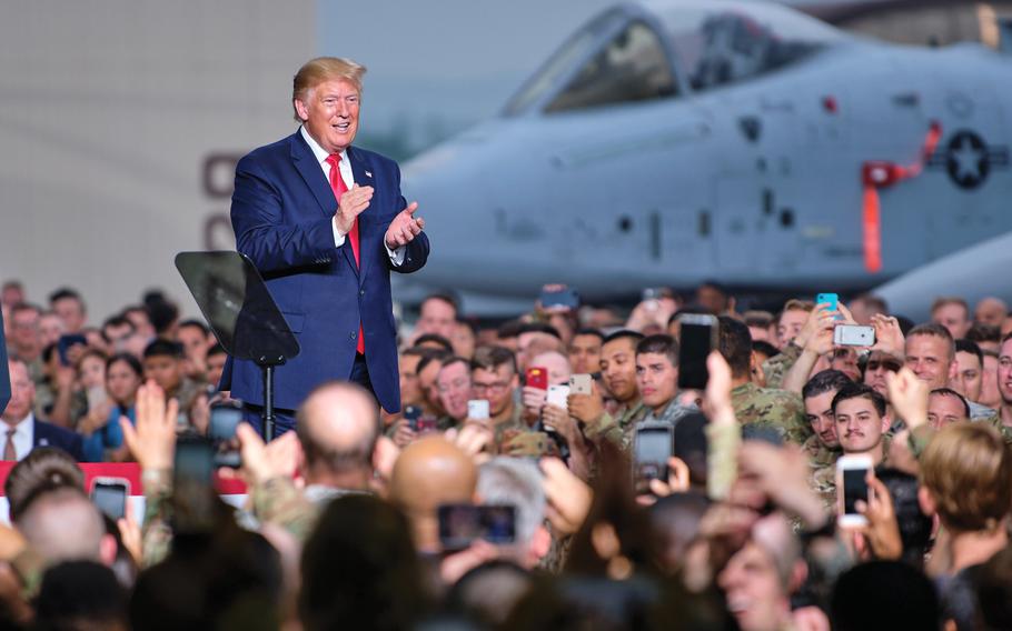 Then-President Donald Trump applauds service members and families during a 2019 speech at Osan Air Base, South Korea. In an interview this week, Trump gave his thoughts about using troops on the U.S. southern border and what relations with South Korea and NATO would be like if he wins a second term.