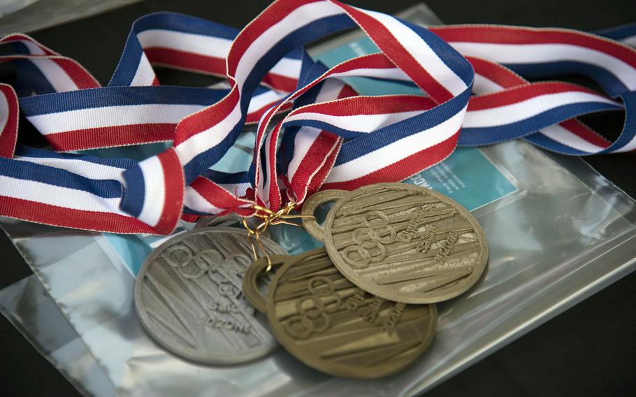 Replica Olympic medals, 3D-printed, are placed inside a time capsule at Yokota Air Base, Japan, Thursday, July 29, 2021. 