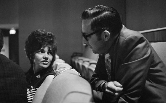 Marilyn Lovell, the wife of astronaut James A. Lovell Jr., Apollo 13 mission commander, discusses the flight with Charles A. Berry, flight surgeon, on April 14, 1970. The two are in a special viewing area overlooking the Flight Control Room.