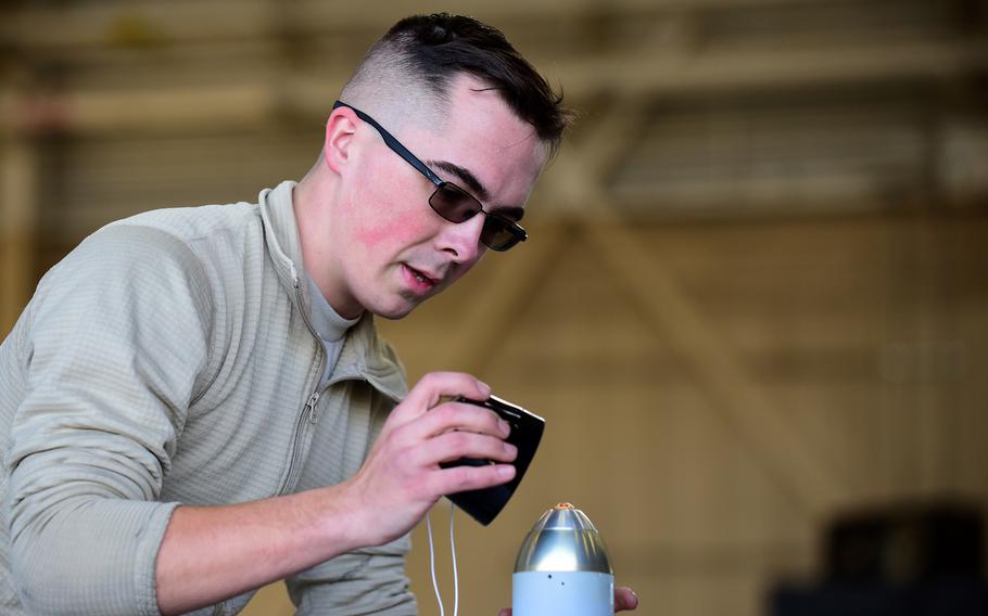 Then-Airman 1st Class Charles Crumlett prepares a weapon to be loaded during a crew competition in January 2018 at Seymour Johnson Air Force Base, N.C.