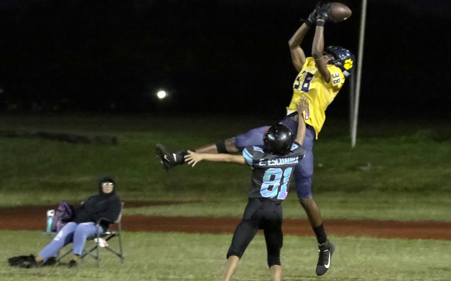 Guam High's Robbie Ellis goes airborne to make a circus catch on a two-point conversion pass.