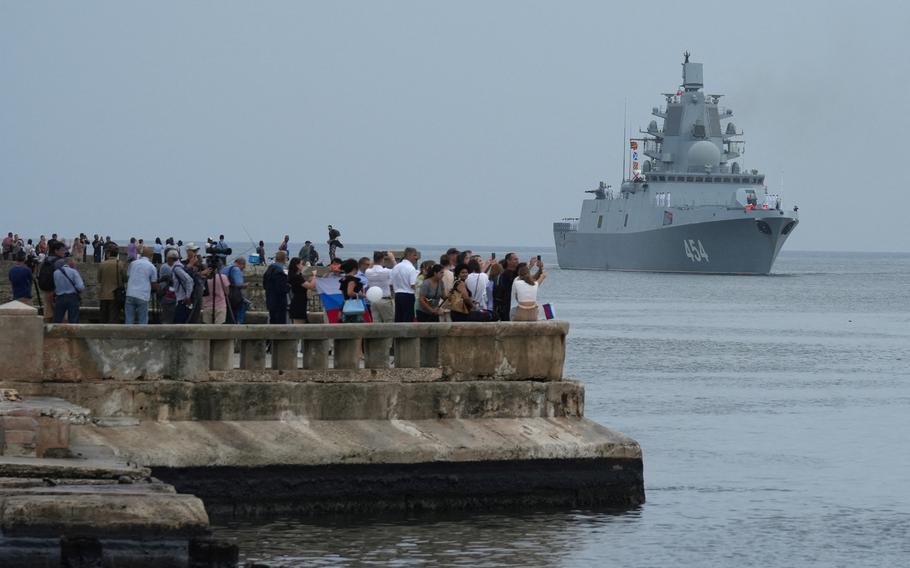 People watch Russian frigate Admiral Gorshkov as it enters the bay in Havana, Cuba, June 12, 2024.