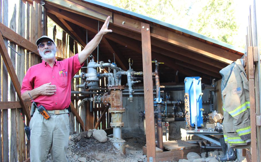 Paul Hewett leads a tour of the off-grid systems at Breitenbush Hot Springs every Saturday afternoon. Here he shows off the 800-foot artesian well, drilled by Breitenbush worker-owners themselves, which provides heat for all structures on the property.