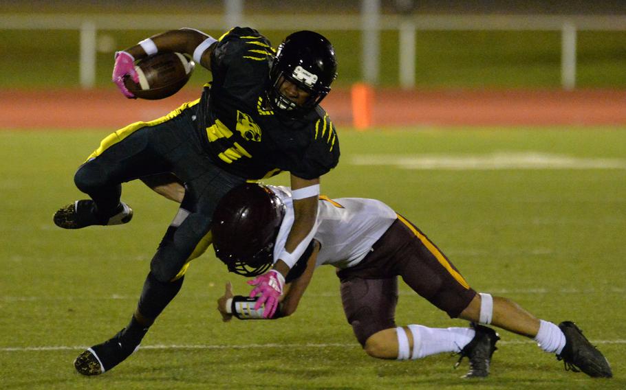 Vilseck’s Gabriel Morell trips up Stuttgart’s Deshawn Lewis in the DODEA-Europe Division I football championship game at Kaiserslautern, Germany, Oct. 29, 2022. Stuttgart won the game 51-12.