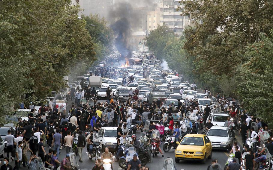 In this photo taken by an individual not employed by the Associated Press and obtained by the AP outside Iran, protesters chant slogans during a protest over the death of a woman who was detained by the morality police, in downtown Tehran, Iran, Sept. 21, 2022.  