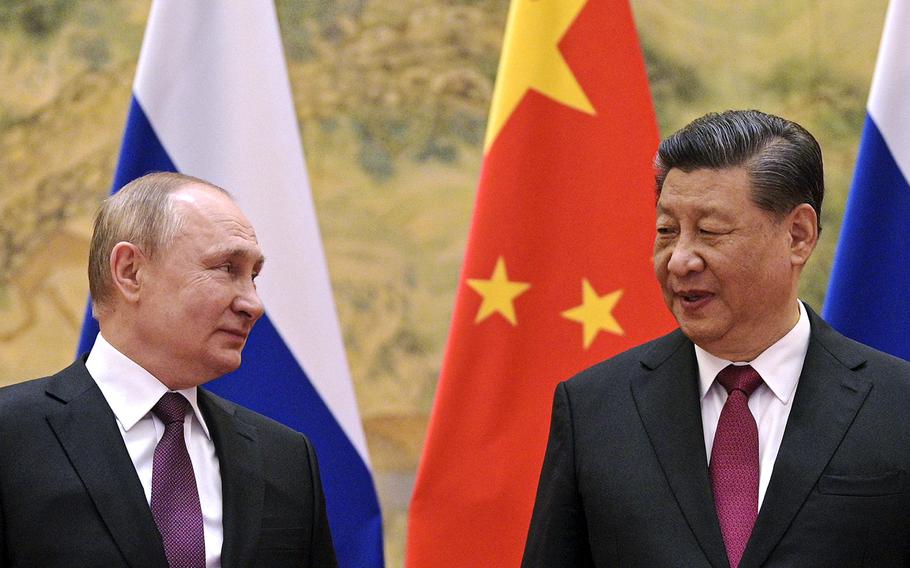 Chinese President Xi Jinping, right, and Russian President Vladimir Putin talk to each other during their meeting in Beijing, China on Feb. 4, 2022. According to reports on Friday, March 17, Xi is set to visit Putin in Russia.