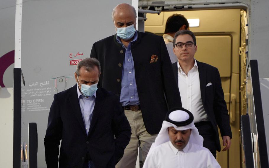 From left, Emad Sharghi, Morad Tahbaz and Siamak Namazi, former prisoners in Iran, walk out of a Qatar Airways flight that brought them out of Tehran and to Doha, Qatar, Monday, Sept. 18, 2023. 