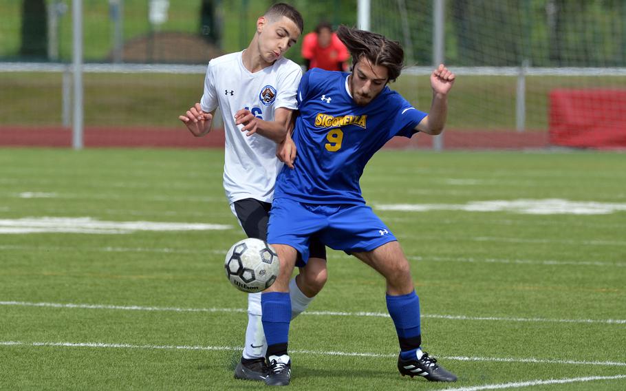 Sigonella’s Teven McCarthy gets a foot in front of Tamaz Kapanadze of Brussels in a Division III semifinal at the DODEA-Europe soccer championships in Kaiserslautern, Germany, May 17, 2023. Sigonella defeated Brussels 6-0 to advance to the final.