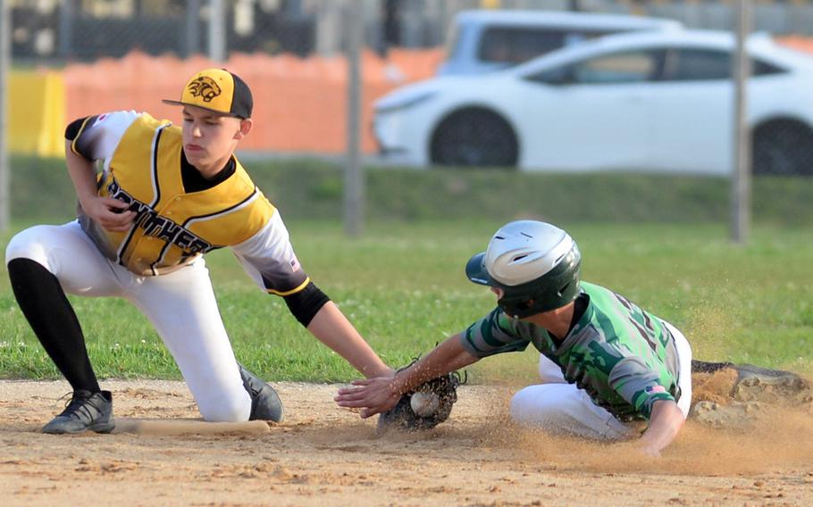 Kadena shortstop Levi Galle applies the tag to Kubasaki baserunner Drake Garza for the out during Wednesday's DODEA-Okinawa baseball game. The Dragons won 12-2.