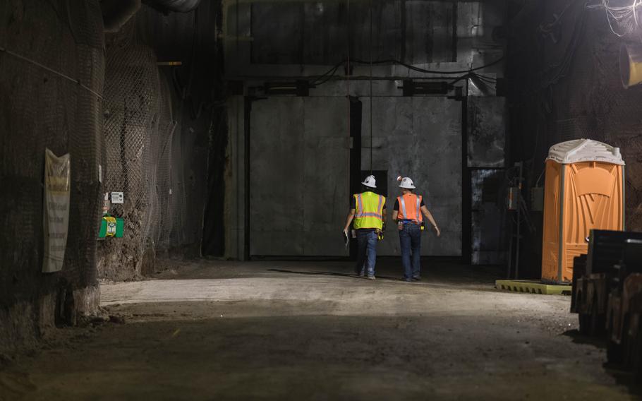Workers walk in a geological repository, U.S. Department of Energy’s Waste Isolation Pilot Plant, storing transuranic radioactive waste in the desert between Hobbs and Carlsbad on Aug. 17, 2021