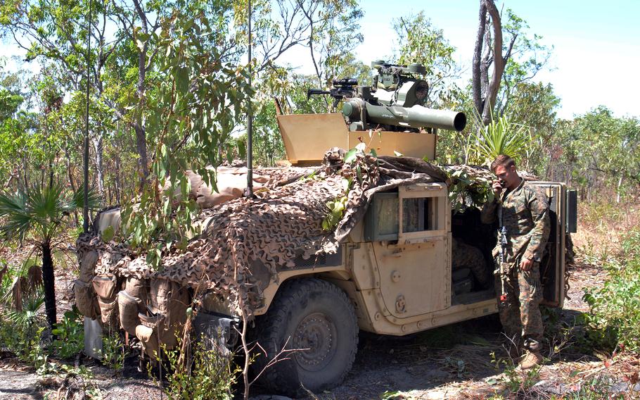 A U.S. Marine talks over a radio near a Humvee equipped with a missile launcher during Exercise Predator's Run at Mount Bundey Training Area in Australia's Northern Territory, Wednesday, Aug. 24, 2022. 