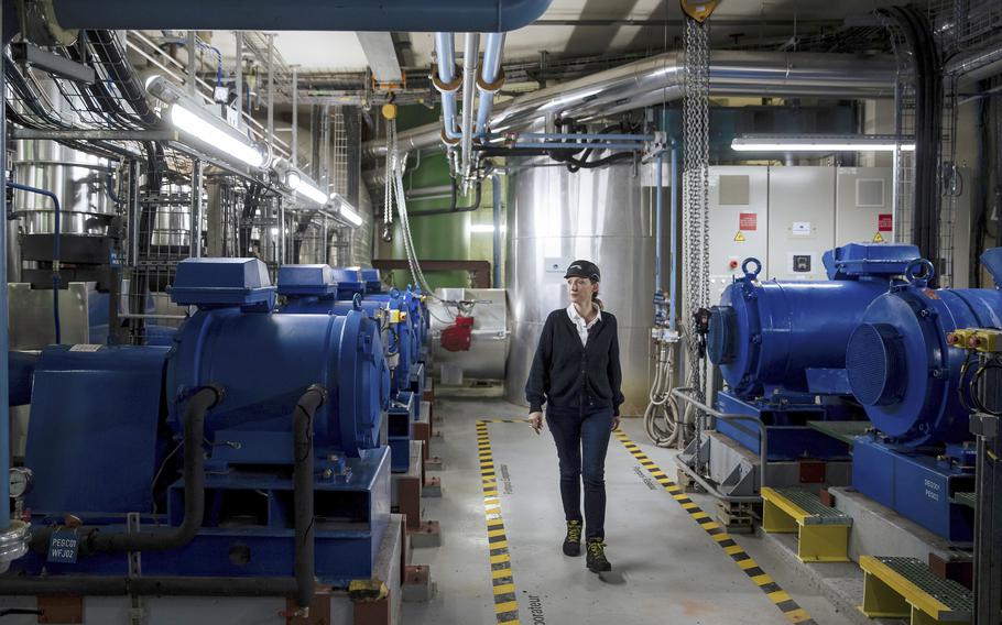 Maggie Schelfhaut, communication manager of Fraicheur de Paris, walks through one of the company's underground cooling sites during a visit in Paris, Tuesday, July 26, 2022. 