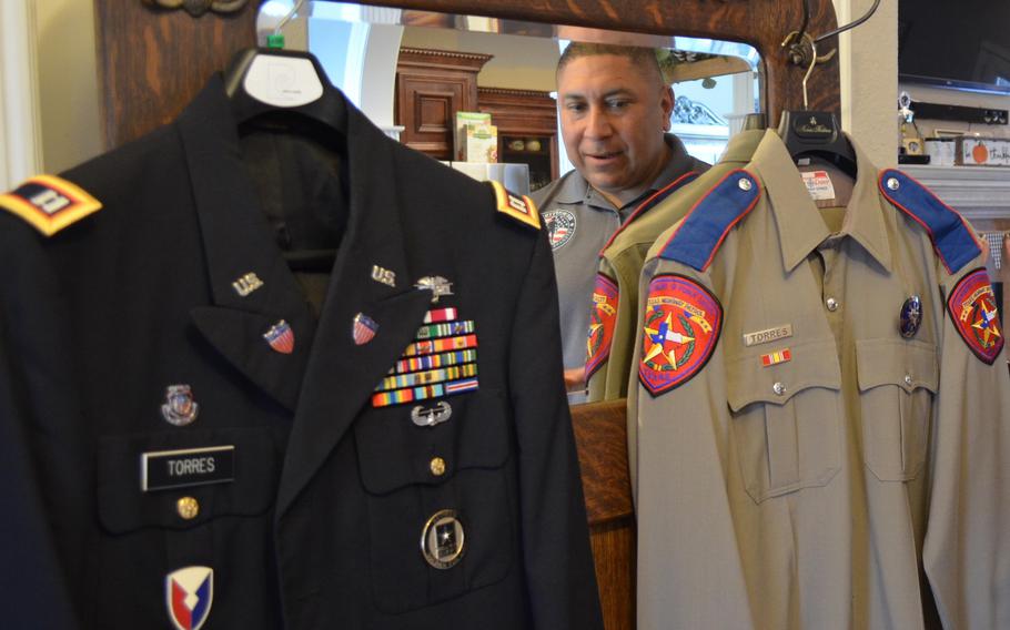 Le Roy Torres looks at the two uniforms that defined his adult life — his final dress uniform from 23 years in the Army and Army Reserve, from which he medically retired as a captain, and the final uniform that he wore during his 14 years as a Texas state trooper, at his home in Robstown, Texas, on Oct. 3, 2019. Torres sued the state of Texas in 2017 because he believed he was forced out of his job as a trooper due to injuries that he sustained on deployment. A jury on Sept. 29, 2023, agreed with him and awarded him nearly $2.5 million. 