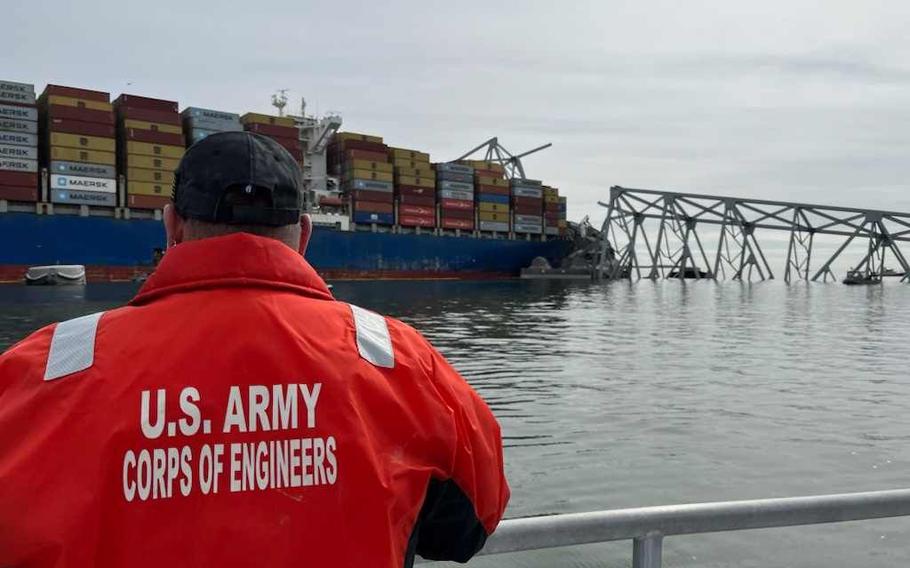 U.S. Army Corps of Engineers navigation staff observe the damage resulting from the collapse of the Francis Scott Key Bridge in Baltimore, Tuesday, March 26, 2024.