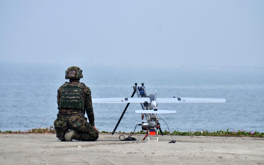A Taiwanese marine prepares to launch a drone over the Taiwan Strait from a coastal training area near Kaohsiung, Taiwan, Jan. 12, 2023.