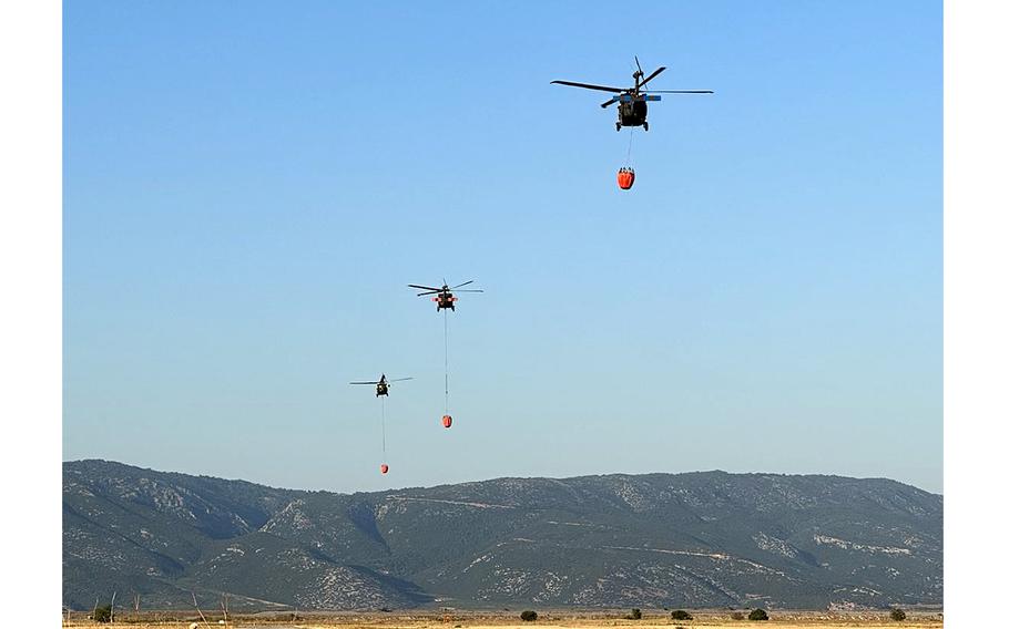Three helicopters deployed to Greece support firefighting efforts July 28, 2023, near the coastal town of Volos, north of Athens.