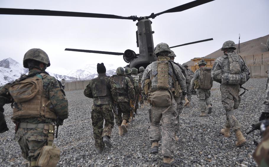 U.S. and Afghan troops head toward a Chinook helicopter at Combat Outpost Blackhawk in Wardak province for an air assault mission in response to reported Taliban activity in an outlying village.