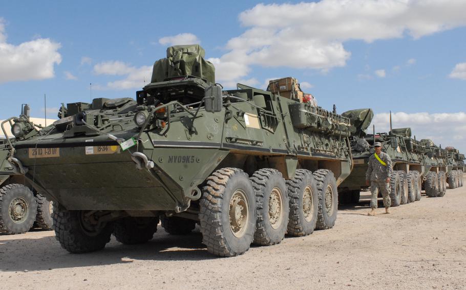 Pfc. Matthew Becerra of the 25th Infantry Division, 2nd Stryker Brigade Combat Team, 1-21 Infantry inspects and prepares his Stryker armored personnel carrier to be fitted with MILES gear to enhance training during their rotation through the National Training Center.