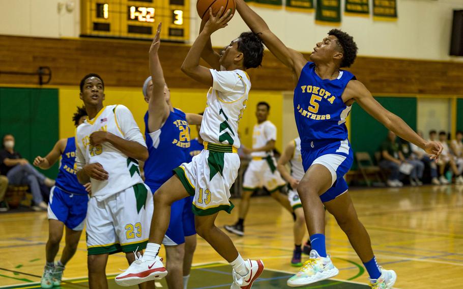 Robert D. Edgren's Micah Magat has his shot blocked by Yokota's Zemon Davis during Friday's DODEA-Japan basketball game. The Panthers won 55-28.