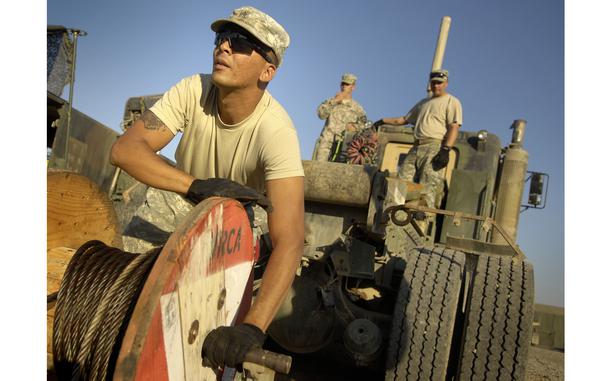 Baqouba, Iraq, Sept. 24, 2009: Army Sgt. Abdiel Cabrerra, a mechanic from B company, 296th Brigade Support Battalion, feeds new tow cable during maintenance on a 5-ton truck Thursday at Forward Operating Base Warhorse, Iraq.  Responsible for maintaining nearly 1,000 vehicles, the 296th BSB deployed this month from Fort Lewis, Washington, as part of the 3rd Stryker Brigade Combat Team, 2nd Infantry Division.

META TAGS: Operation Iraqi Freedom; U.S. Army; BCT; Infantry; Wars on Terror