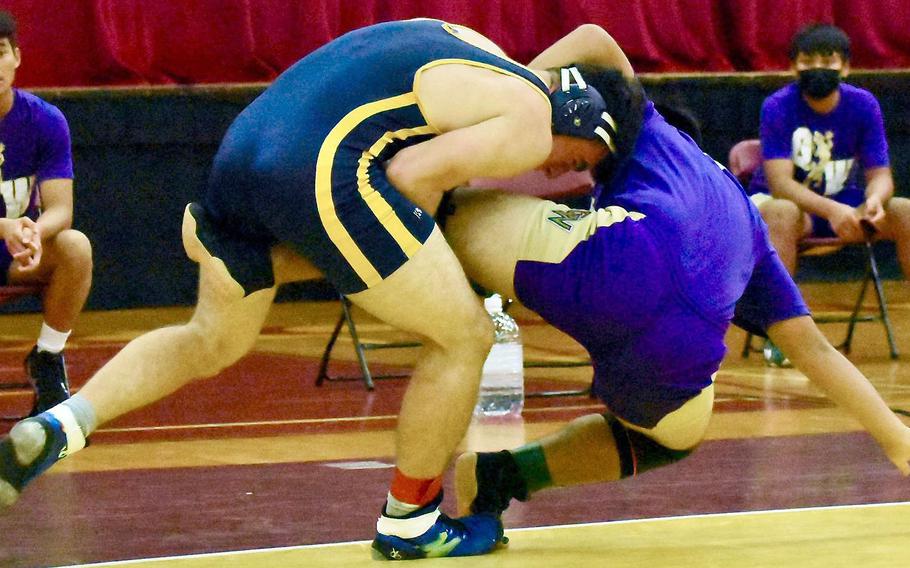 Guam High's Jack Ellis finishes a single-leg takedown en route to pinning George Washington's Jacob Blass in 1 minute, 19 seconds.