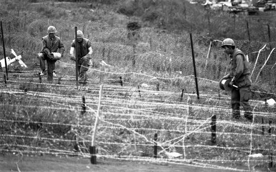 Khe Sanh, South Vietnam, Mar. 10, 1968: Marines lay down barbed wire on the perimeter of Khe Sanh base. North Vietnamese troops harassing the base in recent months with rockets, artillery and mortar fire. The enemy has been working its way closer to the base with some trench lines as close as 100 meters from the outer perimeter.

Looking for Stars and Stripes’ coverage of the Vietnam War? Subscribe to Stars and Stripes’ historic newspaper archive! We have digitized our 1948-1999 European and Pacific editions, as well as several of our WWII editions and made them available online through https://starsandstripes.newspaperarchive.com/

META TAGS: Pacific; South Vietnam; Vietnam War; battle; war; Khe Sanh; combat; Tet offensive; USMC; Marine base; Marines; supply base; barbed wire