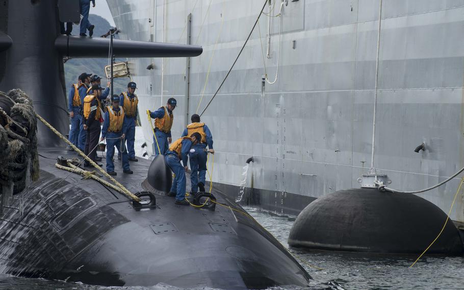 Sailors assigned to the Japan Maritime Self-Defense Force submarine JS Soryu (SS-501) moor port-side along the U.S. Navy submarine tender USS Frank Cable (AS 40) on June 10, 2018, in Polaris Point, Guam. 